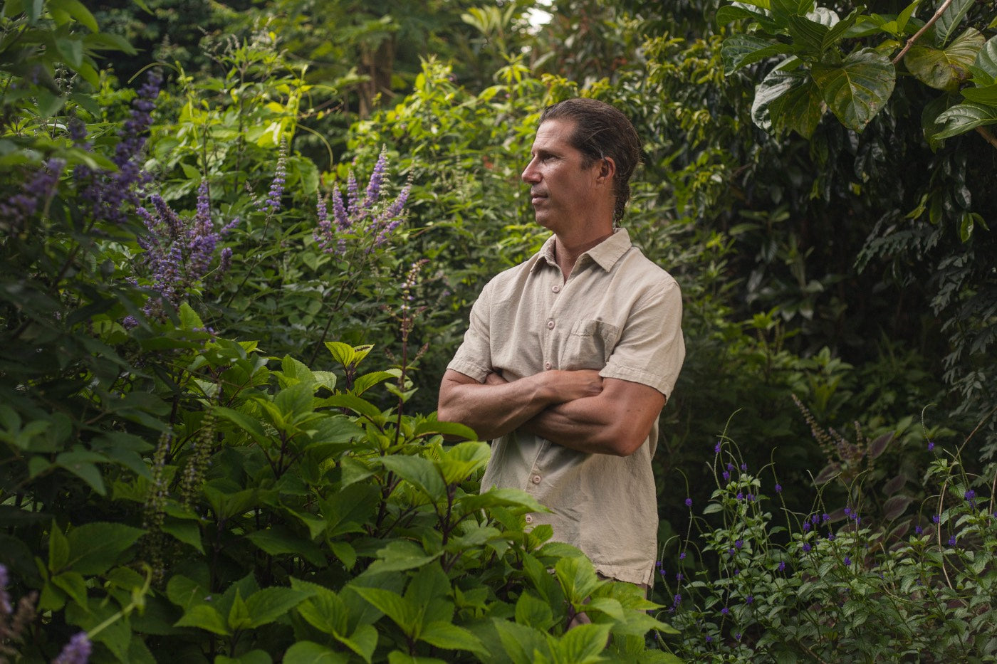 Doug standing amongst the flowering jungle garden